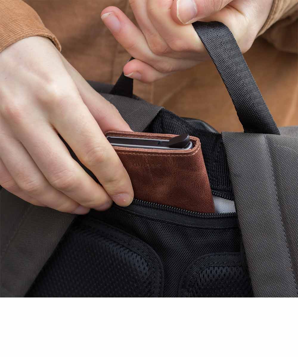 Property of Max reflective roll top backpack