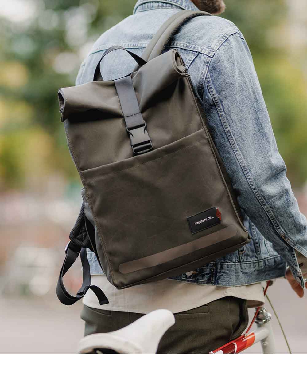 Property of Max reflective roll top backpack
