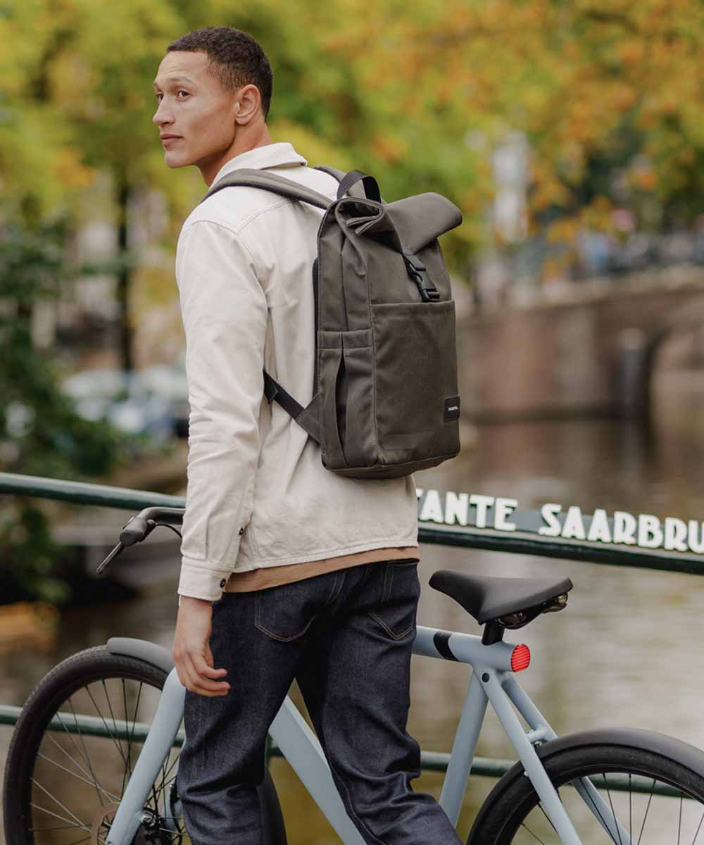 Property of Max reflective roll top backpack
