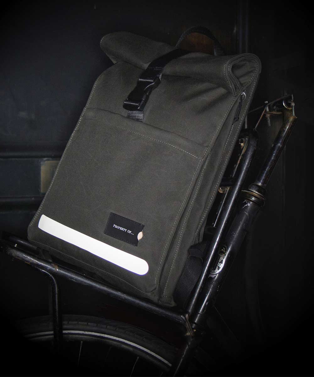 Property of Max reflective roll top backpack