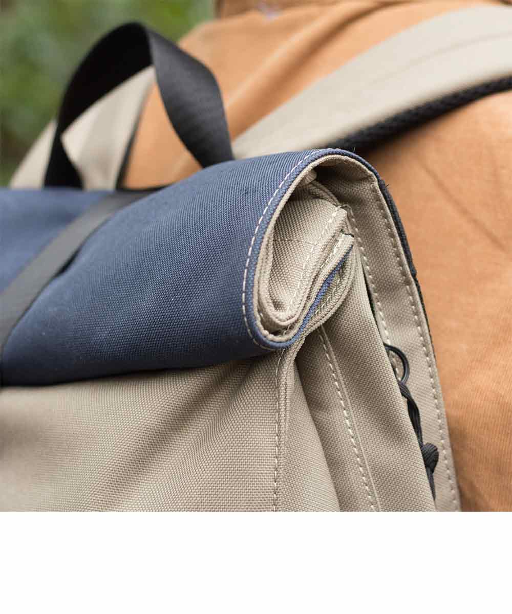 Property of Max reflective roll top backpack