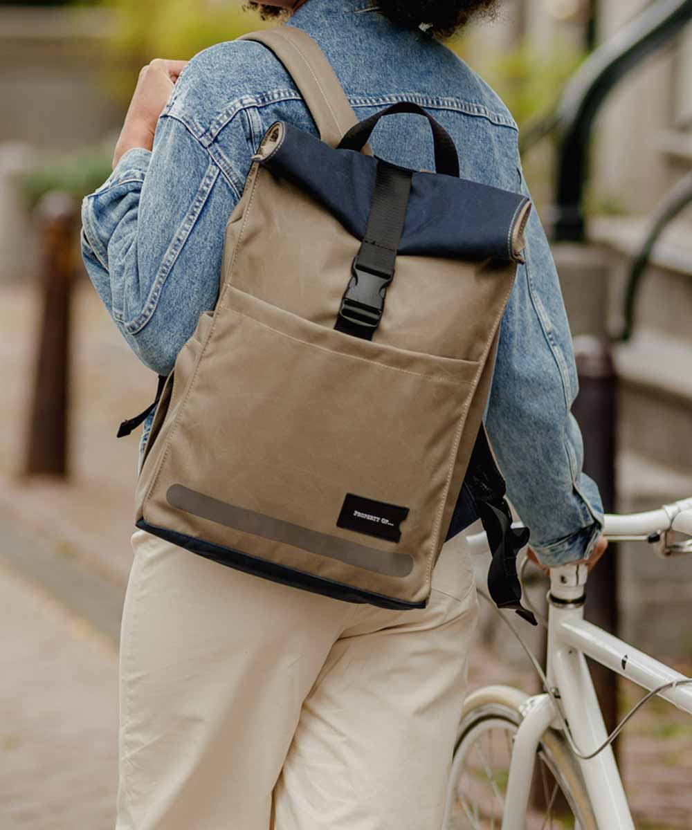 Property of Max reflective roll top backpack