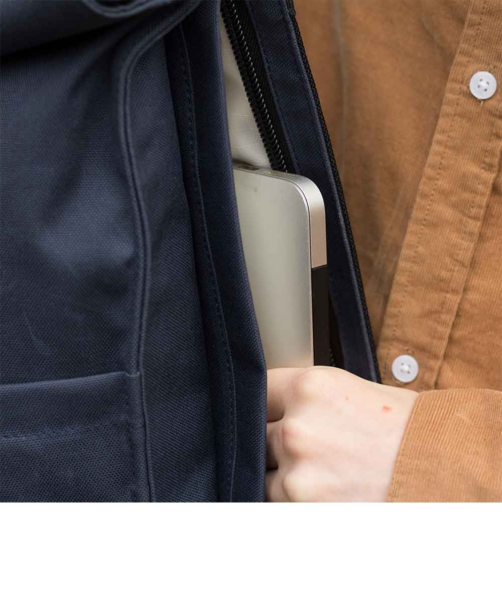 Property of Max reflective roll top backpack