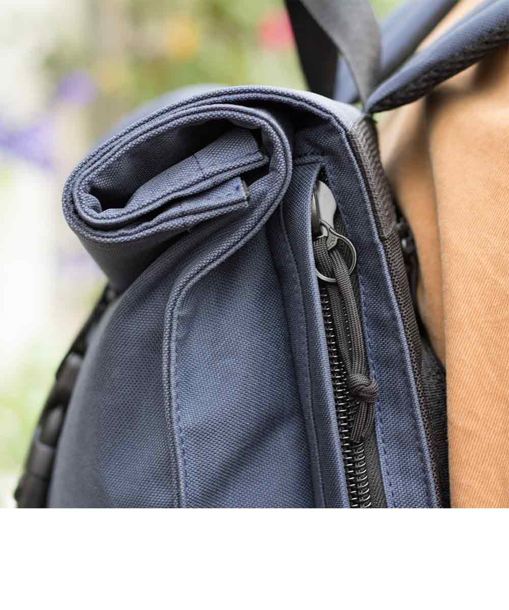 Property of Max reflective roll top backpack