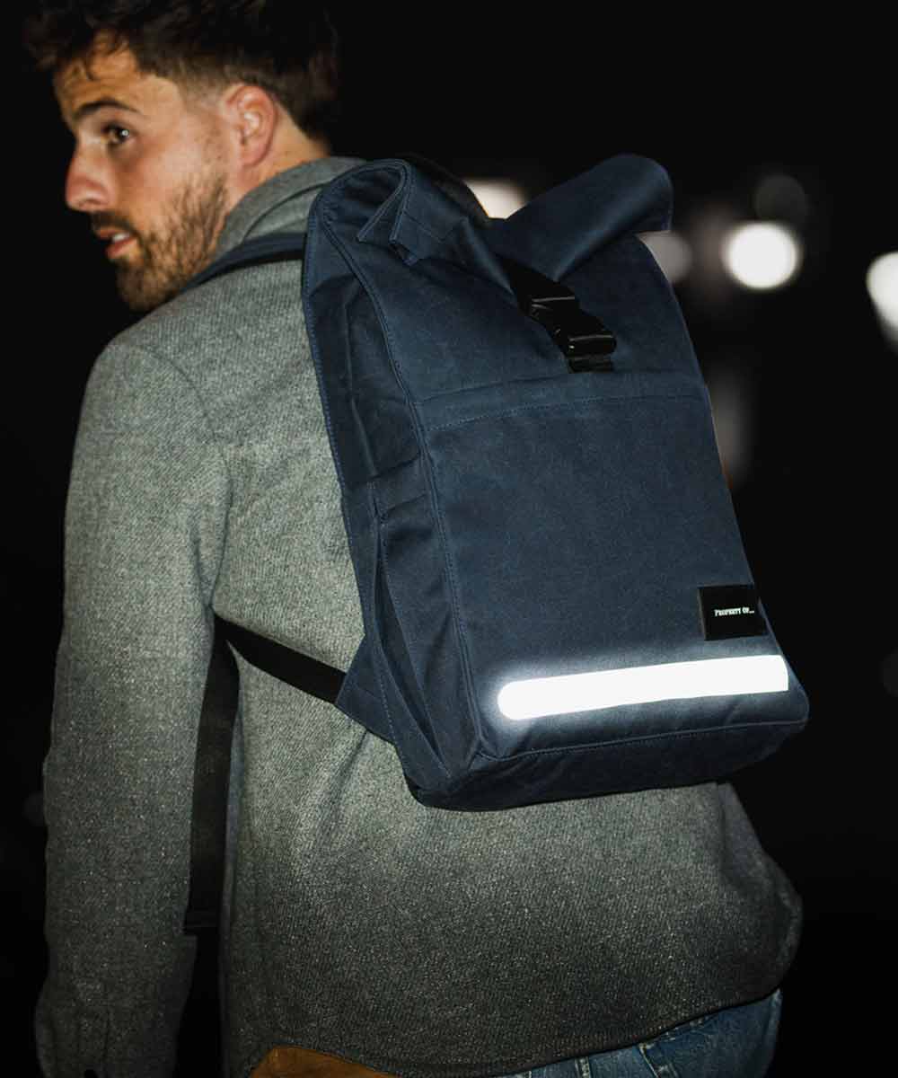 Property of Max reflective roll top backpack